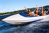 Speed Boat with people waving as they go though the water Speed Boat with people waving as they go though the water